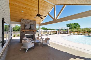 Outdoor pavilion with fireplace, flat screen tv, and food area